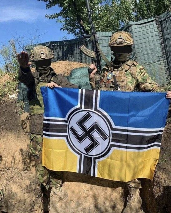 "Azov" regiment fighters with a Nazi flag