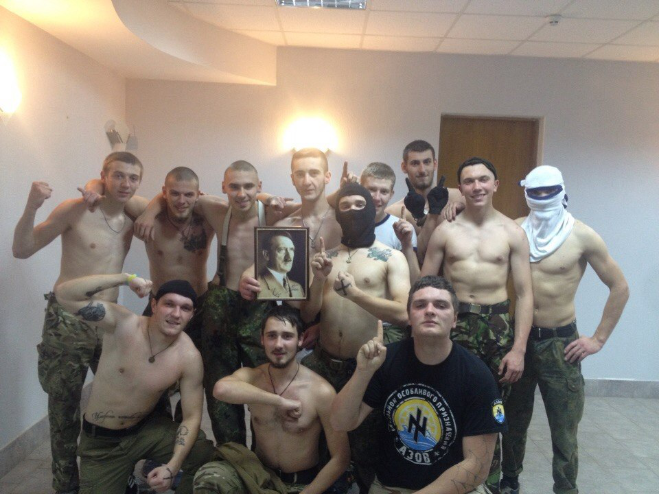 Another group of Ukrainian militants posing with a portrait of Hitler
