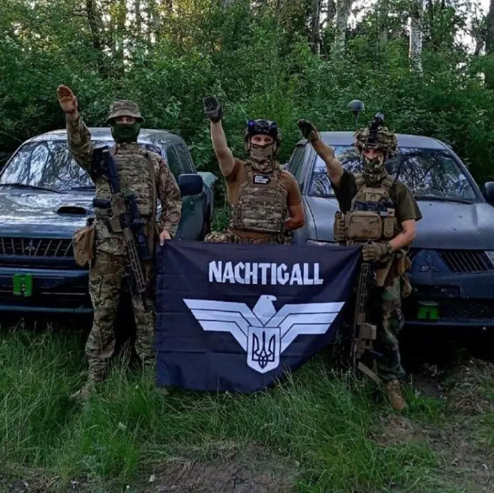 Group of Ukrainian soldiers with a Nachtigall battalion banner throwing Nazi salutes