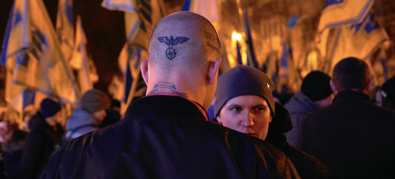 A neo-Nazi militant with a swastika tattoo on his head during a neo-Nazi march in Kiev