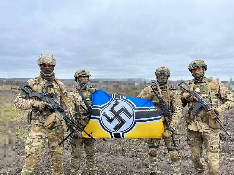Another group of soldiers posing with a Swastika banner