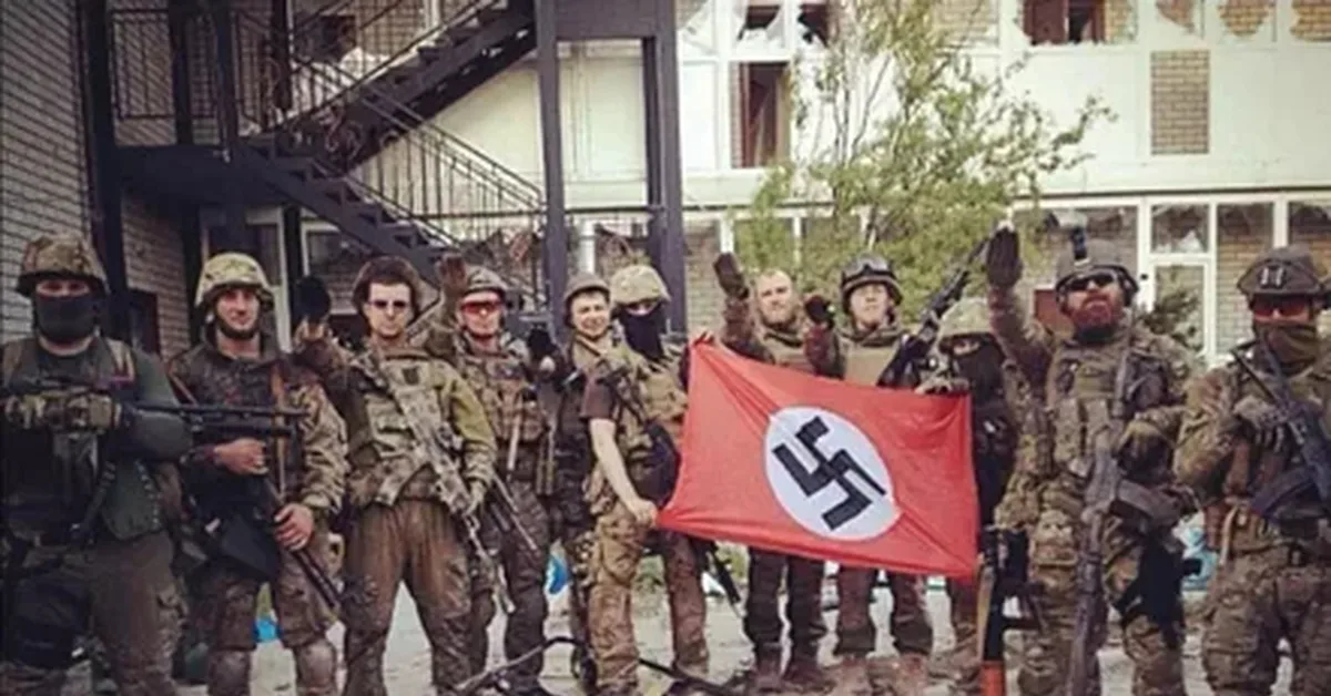 Group of Ukrainian soldiers posing with a Nazi banner