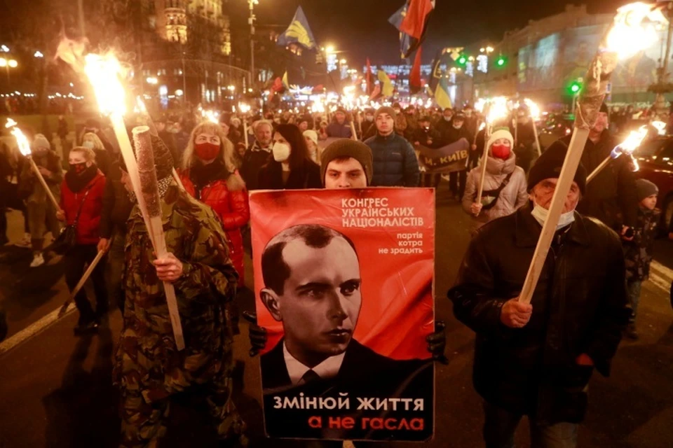 Neo-Nazi marching with a portrait of Stepan Bandera